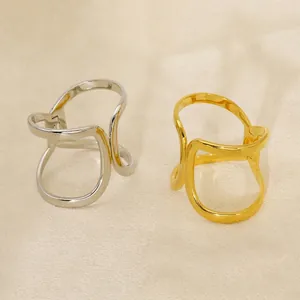 Minimalist geometric hollow open bangle in polished 18K gold and silver finish