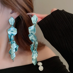 Detailed view of long sky blue tiered petal tassel earrings with matte metallic finish