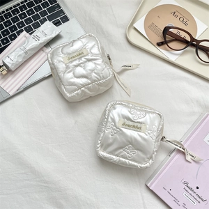 Quilted cream PU leather organizer pouches with heart patterns and decorative ribbons