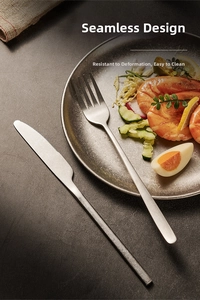 Detail of vintage snowflake gray stainless steel knife and fork set on a salad plate