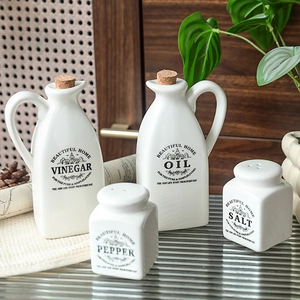 Minimalist white ceramic oil and vinegar dispenser set with salt pepper shakers