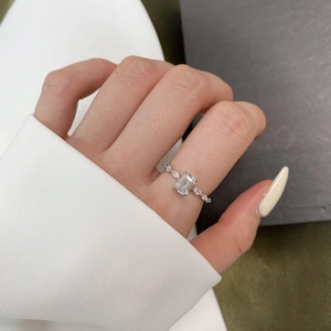 Close-up of S925 silver ring featuring emerald-cut clear stone and side accent stones