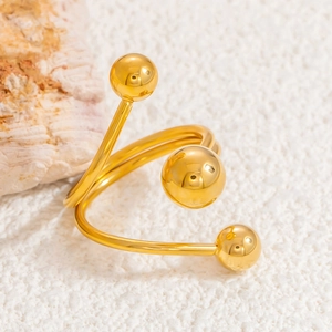 Detailed shot of golden 18k gold-plated planet ring with triple bead spiral design