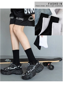 Detailed texture of breathable ribbed knit athletic socks in classic black and white