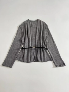 Detailed flat lay of a gray knit cardigan with a slim black belt and golden buckle