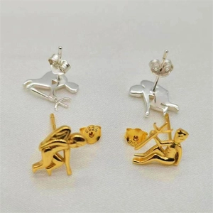 Macro shot of S925 sterling silver angel and demon body earrings in gold and silver finish