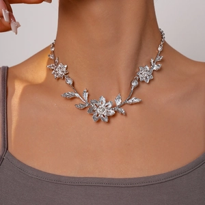 Macro detail of silver leaf and flower necklace with sparkling rhinestones on neck