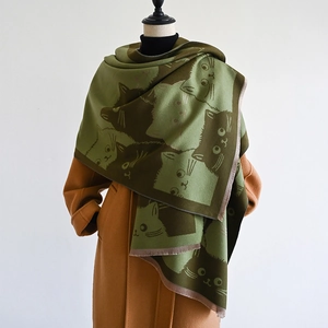 Detailed view of the army green and dark brown scarf with cartoon cat patterns and tassels