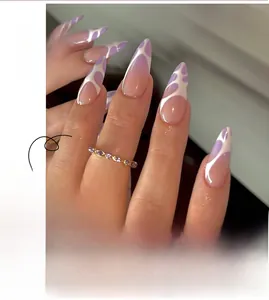 Detailed view of stiletto press-on nails with purple and white abstract graffiti design