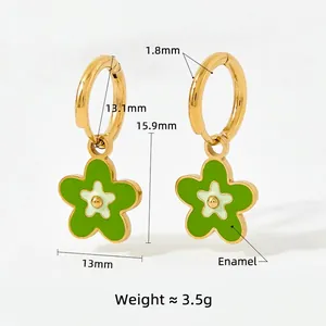 Golden flower hoop earrings with grass green enamel charms in a symmetrical layout