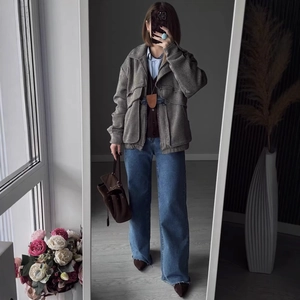 Short grey herringbone workwear jacket paired with blue wide-leg jeans in a mirror selfie