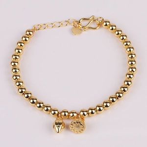 Golden titanium steel beaded bracelet with heart and lotus pod charms on white background