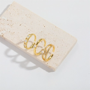 Three gold zircon rings including a square inlay band and a double-row open ring on stone