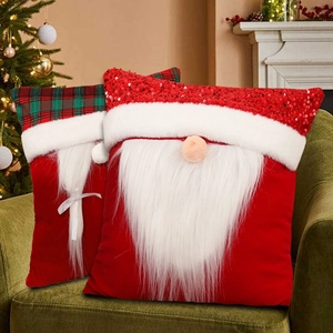 Christmas Santa plush pillows with sequined and plaid hats on green velvet sofa