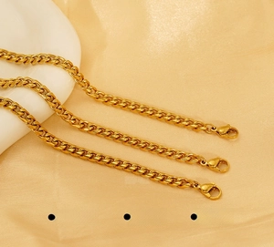 Detailed macro view of 18K gold-plated stainless steel Cuban chains with polished finish