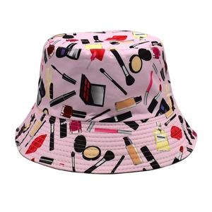 Detailed close-up of pink bucket hat with cosmetic prints showing perfume and lipstick icons