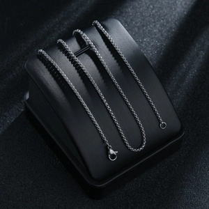 Close-up of 2mm silver stainless steel box chain with secure lobster clasp on black stand