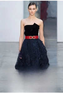 Detail of red elastic waist belt featuring a gold double ring buckle with inlaid pearls