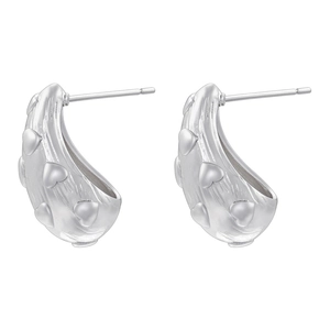 Detailed view of silver hoop earrings featuring embossed heart patterns on polished surface