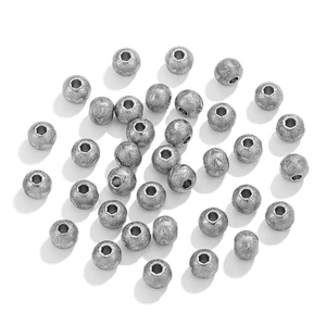 Macro shot of silver frosted stainless steel beads with hexagonal holes for jewelry DIY