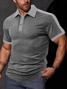 Detail of grey color-block men's polo shirt showing the fine knitting texture and slim fit