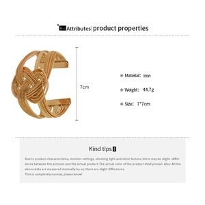 Detail view of woven gold metal chain bangle showing iron material and weight specifications
