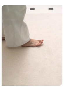 Close-up of bare feet on soft cream chenille rug highlighting skin-friendly comfort