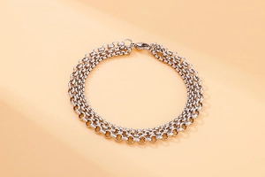 Detailed view of silver stainless steel triple-layer chain bracelet with industrial link design