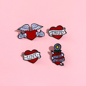 Set of 4 vintage red heart enamel pins with inspirational quotes on pink background