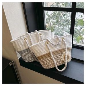 Detailed shot of handmade woven tote bags with flower decor and rope handles on windowsill