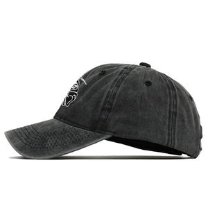 Close-up of Grim Reaper embroidery on washed cotton vintage black baseball cap texture
