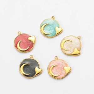 Detail of colorful enamel moon and heart charms with golden stainless steel edges