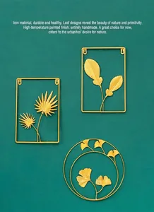 Detailed view of luxury gold iron wall art featuring ginkgo, palm leaves, and feathers