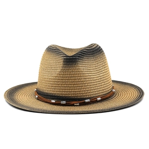 Detail of woven straw fedora with gradient texture and boho beads on a leather band