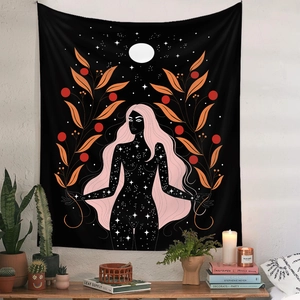 Detailed fabric texture of Bohemian goddess tapestry hanging over a cozy wooden desk