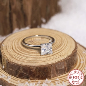 Luxurious 925 sterling silver princess cut diamond ring on wood with snow background