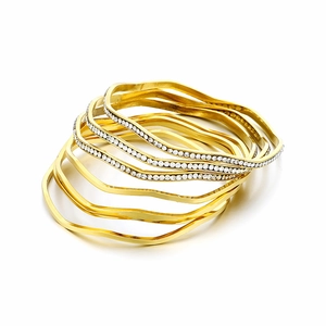 Elegant wavy gold plated titanium steel bangle set with rhinestones on white background