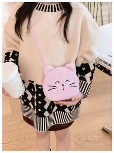 Toddler girl wearing pink plush cat crossbody bag with soft embroidered details