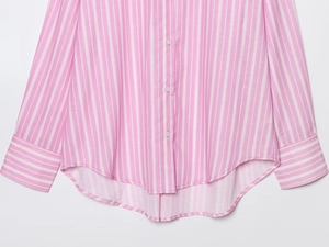 Close-up of pink and white striped shirt featuring button closure and curved hemline