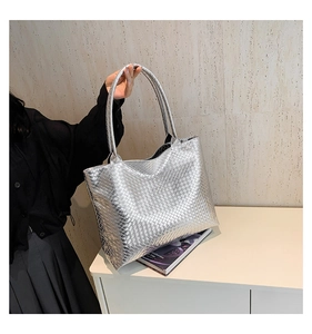 Detailed view of silver metallic woven texture on a large capacity tote bag