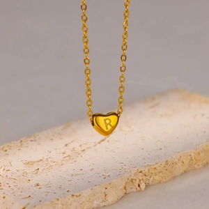 Polished gold plated stainless steel heart necklace featuring engraved letter R pendant