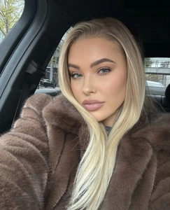 Detail view of brown faux fur jacket with fluffy texture and large lapel collar