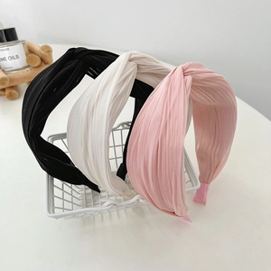 Elegant pleated wide headband set in black, white, and pink fabric with knotted design