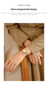 Detailed shot of an octagonal gold watch with a vintage plaid fabric strap on wrist