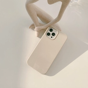 Minimalist cream silicone case for iPhone featuring precise triple camera lens protection