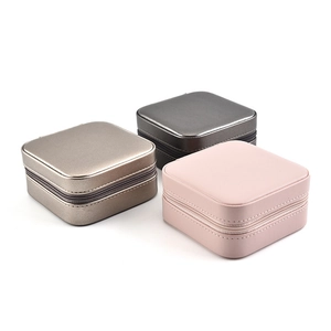 Portable square jewelry boxes with zipper in champagne gold, charcoal grey, and soft pink