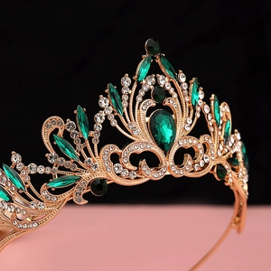 Detailed close-up of golden bridal crown featuring emerald stones and sparking zircons