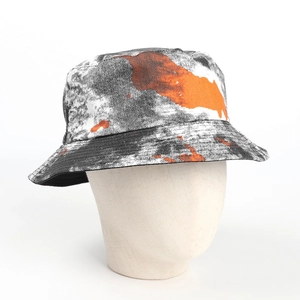 Detail of double-sided bucket hat with orange and black tie-dye splatter print fabric