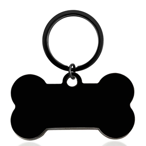 Macro shot of bone shaped black stainless steel pet ID tag with a split ring for collars