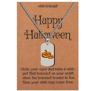 Silver stainless steel Halloween pumpkin tag necklace displayed on a Happy Halloween card